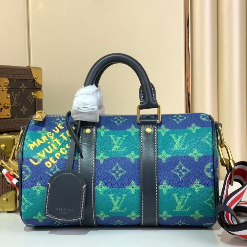 Louis Vuitton colorful duffle travel bag – front view with blue and green geometric pattern and black leather handles