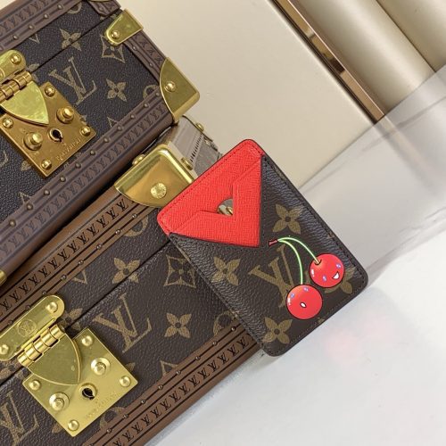 Louis Vuitton monogram trunk bag – close-up of gold lock hardware and cherry red heart patch